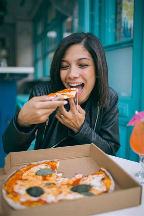 Photo Of Woman Eating Pizza Goldposter Free Stock Photos