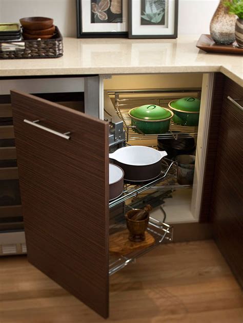 Placing shelves above and below each other on either side of the cabinet won't create more storage space, but it will certainly be easier to find the things. Corner Cabinet Storage Ideas | BloggerLuv.com