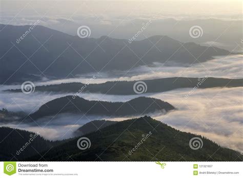 Fantastic View Of Mountain Valley Covered With Low White Puffy L Stock