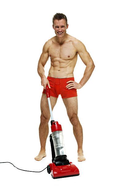 Shirtless Muscular Man Working With Vacuum Cleaner Image