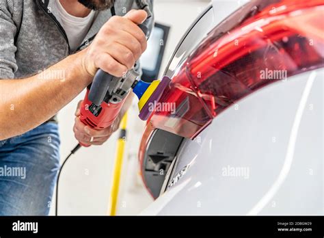 Hand Polishing Car Headlights With The Help Of A Hand Grinder For