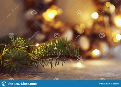 Christmas Decorations With Garland Lights And Fir Tree Branch On A Dark