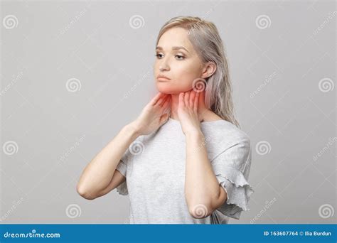 Female Checking Thyroid Gland By Herself Close Up Of Woman In White T