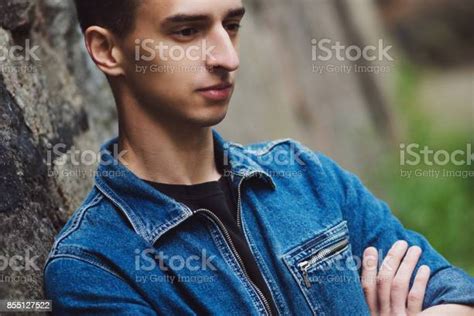 Brooding Young Guy In Denim Walks On The Street Stock Photo Download