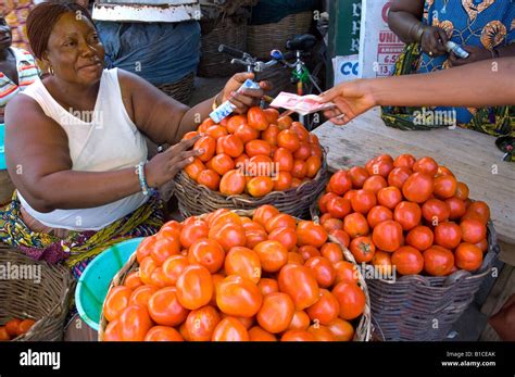 African Woman Selling Tomatoes In A Market In Accra Ghana Stock Photo
