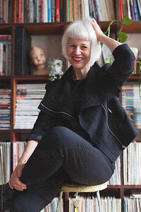 Stylish Older Woman Indoors In Front Of Books And Records By Stocksy Contributor Natalie