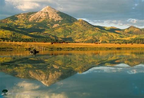 The Mountains Are Reflected In The Still Water