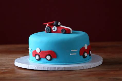 Birthday candles isolated on the white. Racing car themed birthday cake for a 2 year old little ...