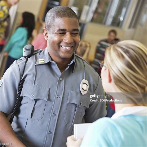 Friendly Police Officer Talking With School Teacher After Safety