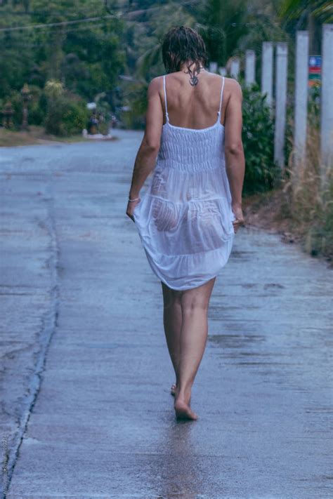 Woman Walking In A Wet Dress After The Rain By Stocksy Contributor Mosuno Stocksy