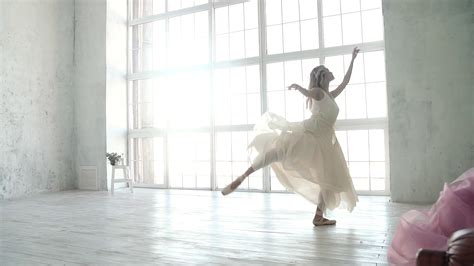 Young Ballet Dancer Dancing On The Background Of A Large Window