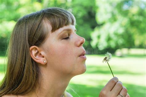Young Woman Blowing Dandelion Flower Stock Photo Image Of Forest