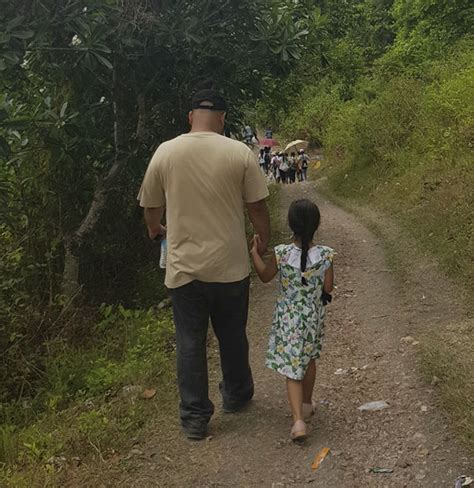 une maman prend discrètement des photos de son mari et sa fille se tenant la main depuis 2014