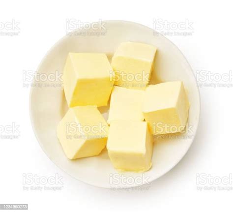 Butter Pieces In White Bowl Isolated Butter Cubes Top View Stock Photo