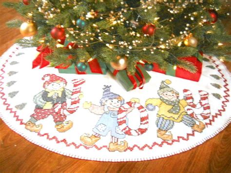 This counted cross stitch pattern village scene at christmas was created from the beautiful artwork of nicky boehme. Counted Cross Stitch Kit Joyous Elves Christmas Tree Skirt ...