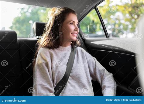 Passenger In Taxi Or Woman In Car Sitting On The Backseat Looking Outside The Window Happy