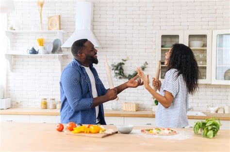 Husband And Wife Having Fun Singing In The Kitchen Stock Photo Image