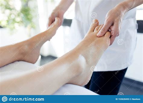 Pregnant Woman Enjoying Reflexology Foot Massage In Wellness Spa Stock