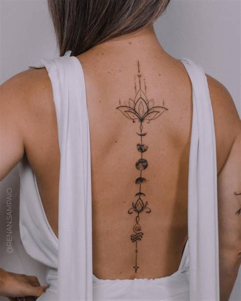 Moon Phases Tattoo Located On The Spine