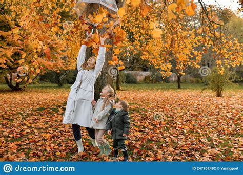 Kids And Mother Play In The Autumn Park Stock Photo Image Of Knitted