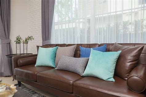 Blue And Gray Pillows On Leather Sofa In Modern Living Room Stock Image