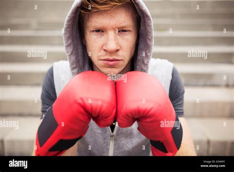 A Photo Of Young Boxer With Red Boxing Gloves On His Hands A Hood On