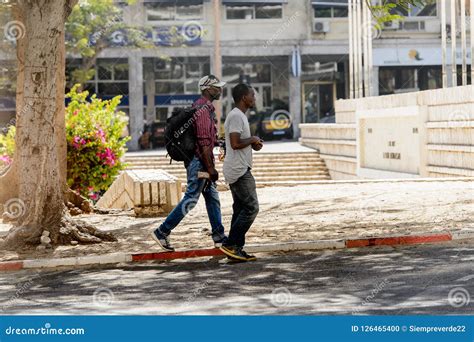 Unidentified Senegalese Two Men Walk Beside The Road In Dakar