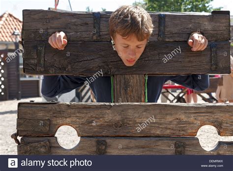 A Boy Trapped In A Medieval Torture Device Stock Photo Alamy