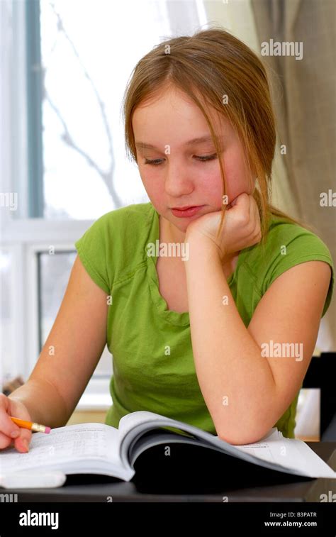 Young School Girl Doing Homework At Her Desk Stock Photo Alamy