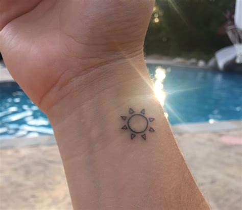 simple sun tattoo wrist