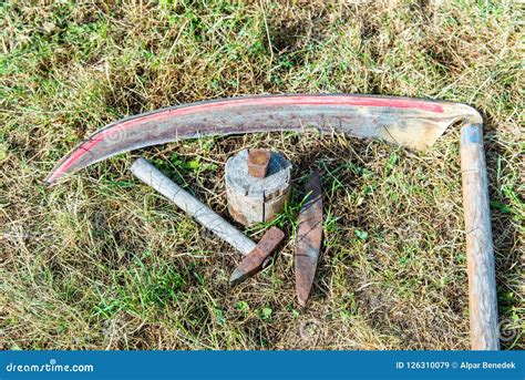 Traditional Scythe With Sharpening Tools On The Grass Stock Image