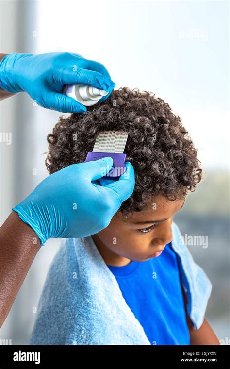Mother Checking Childs Head For Lice With A Comb Stock Photo Alamy