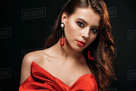 Portrait Of Beautiful Brown Haired Girl In Red Corset And Earrings