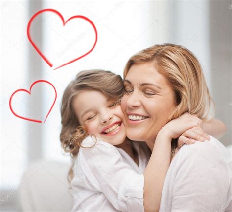 Smiling Mother And Daughter Hugging Stock Photo By ©sydaproductions