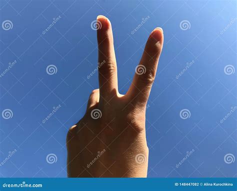 Two Fingers Up On A Blue Background Stock Photo Image Of Background