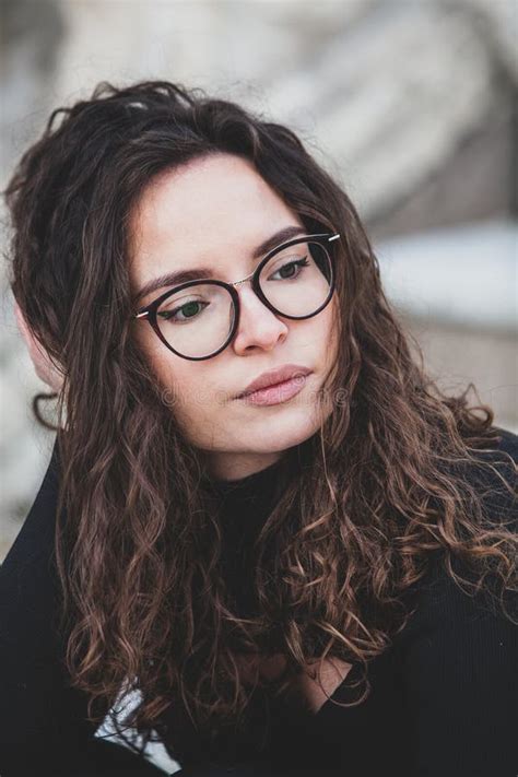 Beautiful Young Woman With Brunette Curly Hair Portrait In Eye Glasses Enjoying The Sun Stock