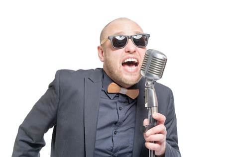 Premium Photo A Man In A Gray Jacket Bow Tie And Sunglasses Singing