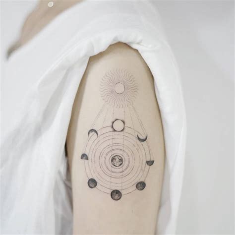 Eclipse Tattoo On The Left Upper Arm