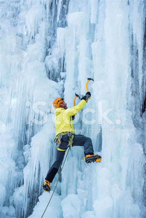 Ice Climber Ascending A Frozen Waterfall Stock Photo Royalty Free