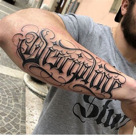 Image May Contain One Or More People And Beard Tattoo Lettering