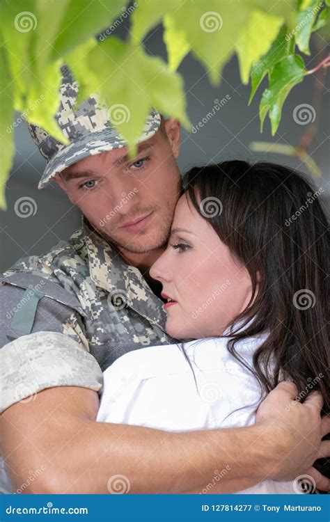 Soldier Leaving Home As Wife Watches On Stock Image 127814095