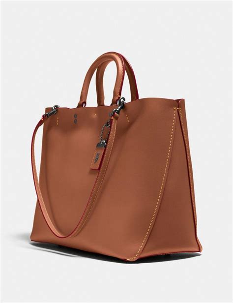 Coach began as a family their size and versatility make them ideal as either a daytime or overnight bag, and with their long slender straps they always sit comfortably over your shoulder. Rogue Tote | COACH