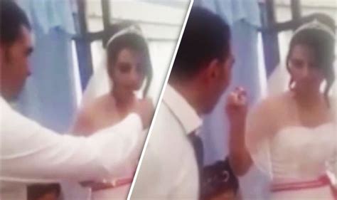 appalling video emerges of groom hitting wife after she attempts to feed wedding cake world