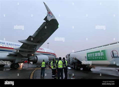 Chinese Ground Crew Members Fuel An Airbus A320 Jet Plane Of China