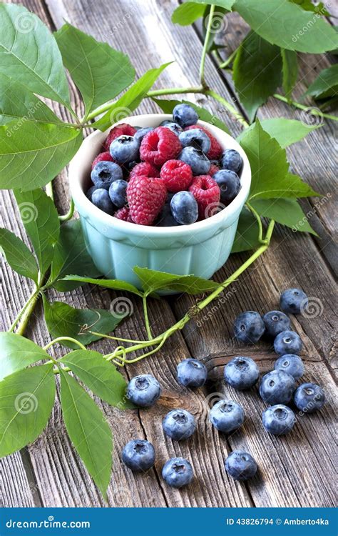 Fresh Berries In A Bowl On A Wooden Table Stock Photo Image Of
