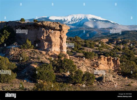 Red Rock Formation With The Snow Capped Peaks Of The Sangre De Cristo