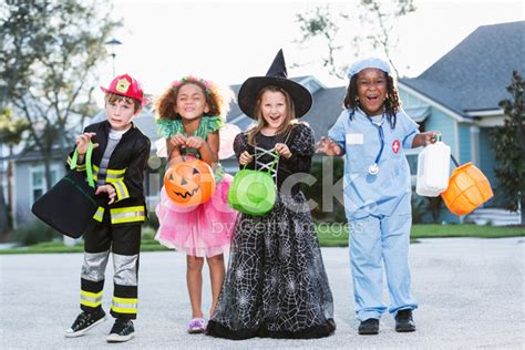 Group Of Children In Halloween Costumes Going Trick Or Treating Stock