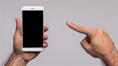 Premium Ai Image Mans Hand Shows Mobile Smartphone With A White
