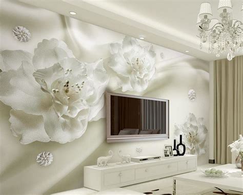 A Living Room With White Furniture And Flowers On The Wall