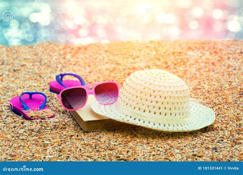 Sun Straw Hat Flip Flop Sandals And Sunglasses Lying On The Beach